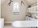 Sunlit home office featuring an arched window and built in shelves at 5475 Copper Creek Pass, Cumming, GA 30040