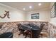 A cozy poker room with a classic poker table and warm brick accents for a perfect game night at 5475 Copper Creek Pass, Cumming, GA 30040