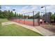 Community tennis court surrounded by greenery, providing a great space for recreation and exercise at 5475 Copper Creek Pass, Cumming, GA 30040