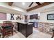 Basement wet bar with granite counters, dark wood cabinets, and brick accents at 5475 Copper Creek Pass, Cumming, GA 30040