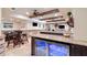 Basement wet bar with granite counters, dark wood cabinets, and beverage cooler at 5475 Copper Creek Pass, Cumming, GA 30040