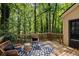 Elevated deck with patio furniture, an outdoor rug, and a view of the surrounding trees at 203 Concorde Sw Way, Lilburn, GA 30047
