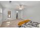 Bright, carpeted bedroom with ensuite bathroom, fan, and large window allowing ample natural light at 203 Concorde Sw Way, Lilburn, GA 30047