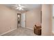 Carpeted bedroom with great natural light, neutral walls, and a view of an attached bathroom at 203 Concorde Sw Way, Lilburn, GA 30047