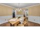 Formal dining area showcasing classic chandelier and warm color palette at 203 Concorde Sw Way, Lilburn, GA 30047