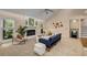Cozy living room featuring a fireplace with painted brick, a ceiling fan and large sunny windows at 203 Concorde Sw Way, Lilburn, GA 30047