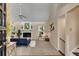 Bright and inviting living room featuring a fireplace, fan, and large windows overlooking a treed yard at 203 Concorde Sw Way, Lilburn, GA 30047
