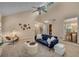 Bright living room featuring a vaulted ceiling, ceiling fan, and large windows overlooking the yard at 203 Concorde Sw Way, Lilburn, GA 30047