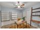 Bright office with built-in shelving, a modern desk, and a stylish ceiling fan at 203 Concorde Sw Way, Lilburn, GA 30047