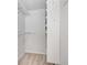 Walk-in closet with carpeted flooring, white shelving, and hanging rods for optimal organization at 203 Concorde Sw Way, Lilburn, GA 30047