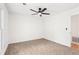 Bright bedroom features a ceiling fan, carpeted floor, and a window with natural light at 250 Huntcliff Ct, Fayetteville, GA 30214