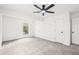 Light bedroom with neutral carpet, ceiling fan, and closet space at 250 Huntcliff Ct, Fayetteville, GA 30214
