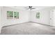 Spacious bedroom with neutral carpet, two large windows, and a ceiling fan at 250 Huntcliff Ct, Fayetteville, GA 30214