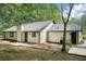 Rear exterior view of the home highlighting the siding, roof, windows, and a small deck area at 250 Huntcliff Ct, Fayetteville, GA 30214