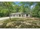 Charming single-story home with a manicured front yard and a two-car garage nestled among mature trees at 250 Huntcliff Ct, Fayetteville, GA 30214