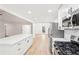 Bright kitchen featuring an island with white countertops, stainless steel appliances and an open floor plan at 250 Huntcliff Ct, Fayetteville, GA 30214