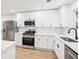 Well-lit kitchen with stainless steel appliances, white cabinets, and quartz countertops at 250 Huntcliff Ct, Fayetteville, GA 30214