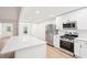 Spacious kitchen features stainless steel appliances, bright white cabinets, and quartz countertops at 250 Huntcliff Ct, Fayetteville, GA 30214
