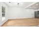 Living room with hardwood floors, large windows, modern lighting, and white walls at 250 Huntcliff Ct, Fayetteville, GA 30214