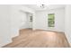 Bright room with hardwood floors, stylish lighting, and plenty of natural light at 250 Huntcliff Ct, Fayetteville, GA 30214