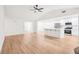 Open concept living room featuring a vaulted ceiling and an open floor plan with a modern kitchen at 250 Huntcliff Ct, Fayetteville, GA 30214