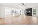 Open floor plan featuring a stone fireplace, vaulted ceiling, ceiling fan and a modern kitchen at 250 Huntcliff Ct, Fayetteville, GA 30214