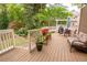 Relaxing outdoor deck area with seating, a grill, and serene backyard views surrounded by lush greenery at 3115 Peachtree Ne Dr, Atlanta, GA 30305