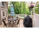Back deck with table, chairs, grill, and bench. Decorated with colorful umbrella and flower pot at 3115 Peachtree Ne Dr, Atlanta, GA 30305