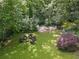 Aerial view of backyard featuring an outdoor lounge, fire pit, hammock, and lush greenery at 3115 Peachtree Ne Dr, Atlanta, GA 30305