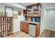 Basement bar area featuring a mini-fridge, wine rack, and glassware storage for entertaining at 3115 Peachtree Ne Dr, Atlanta, GA 30305