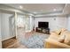 Finished basement with ample seating, TV area, and glass doors offering flexible living space at 3115 Peachtree Ne Dr, Atlanta, GA 30305