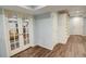 Spacious basement featuring a finished area with wood flooring and stylish glass paneled doors at 3115 Peachtree Ne Dr, Atlanta, GA 30305