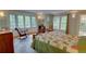 Bedroom with large windows, rocking chair, and neutral color palette offers relaxation at 3115 Peachtree Ne Dr, Atlanta, GA 30305