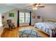 Bedroom with a ceiling fan, hardwood floors, a cozy chair, and large windows at 3115 Peachtree Ne Dr, Atlanta, GA 30305