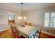 Traditional dining room features a chandelier, hardwood floors, and neutral decor at 3115 Peachtree Ne Dr, Atlanta, GA 30305