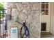 Exterior wall equipped with an electric vehicle charger and stone siding at 3115 Peachtree Ne Dr, Atlanta, GA 30305