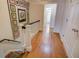 Hardwood hallway with decorative quilt, white trim, and views to bedrooms and a stairwell at 3115 Peachtree Ne Dr, Atlanta, GA 30305