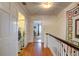 Hallway featuring a laundry room, hardwood floors, and a view of a bedroom at 3115 Peachtree Ne Dr, Atlanta, GA 30305