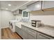 Updated laundry room featuring granite counters, stainless sink, and modern washer and dryer at 3115 Peachtree Ne Dr, Atlanta, GA 30305