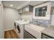 Functional laundry room features gray cabinets, granite countertops, and a farmhouse sink at 3115 Peachtree Ne Dr, Atlanta, GA 30305
