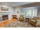 Inviting living room with hardwood floors, fireplace, and large bay window allowing natural light at 3115 Peachtree Ne Dr, Atlanta, GA 30305