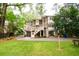Two-story home with a lovely rear exterior, spacious deck, drive-under garage, and lush green lawn at 3115 Peachtree Ne Dr, Atlanta, GA 30305