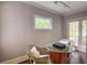 Bright sun room has stylish wicker seating, glass table, and natural light at 3115 Peachtree Ne Dr, Atlanta, GA 30305