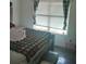 Bright bedroom featuring a wooden bed frame, large window and hardwood floors at 143 Delane Dr, Dallas, GA 30157