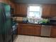 A kitchen with stainless steel appliances, dark countertops, oak cabinets and tile flooring at 143 Delane Dr, Dallas, GA 30157