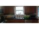 A kitchen with stainless steel appliances, dark countertops, oak cabinets and tile flooring at 143 Delane Dr, Dallas, GA 30157