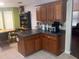 A kitchen with stainless steel appliances, dark countertops, oak cabinets and tile flooring at 143 Delane Dr, Dallas, GA 30157