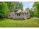 Beautiful backyard featuring lush greenery and a view of the home's rear exterior at 230 Deer Forest Rd, Fayetteville, GA 30214