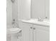 Bathroom featuring marble-look ceramic tile, a new toilet and a sink with a chrome faucet at 230 Deer Forest Rd, Fayetteville, GA 30214
