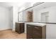 Stylish bathroom featuring dual vanities and a large mirror, complemented by wood floors at 230 Deer Forest Rd, Fayetteville, GA 30214